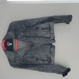 Mezame Designs black jean jacket with pink weaved pattern on back.